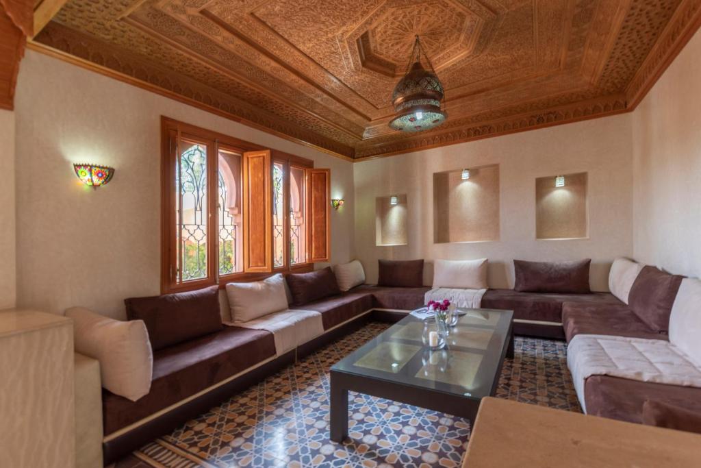 a living room with a couch and a table at Hôtel Riad Airport Marrakech in Marrakech