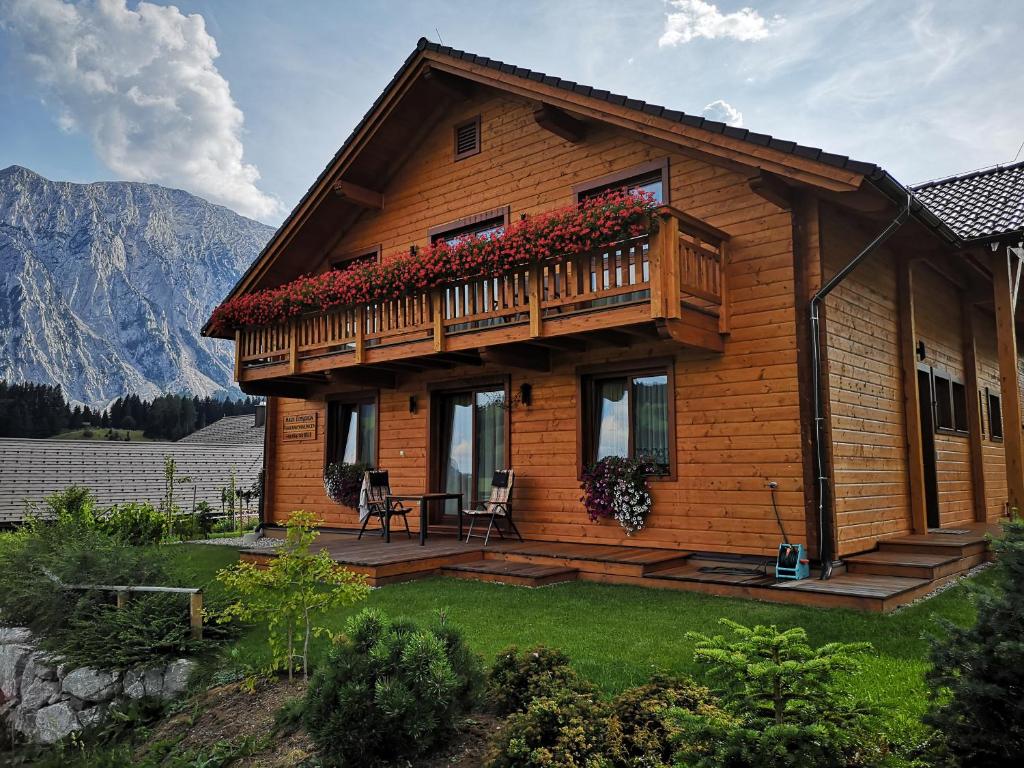 a wooden house with a deck and a balcony at Haus Edelgrün in Tauplitz