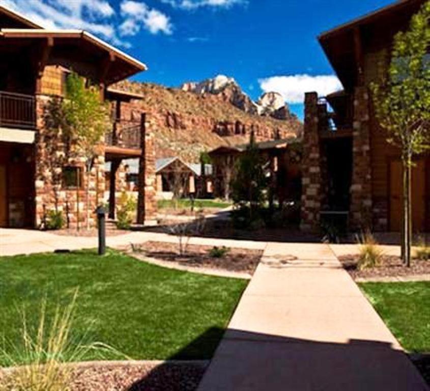 a large brick building with a walkway leading to it at Cable Mountain Lodge in Springdale