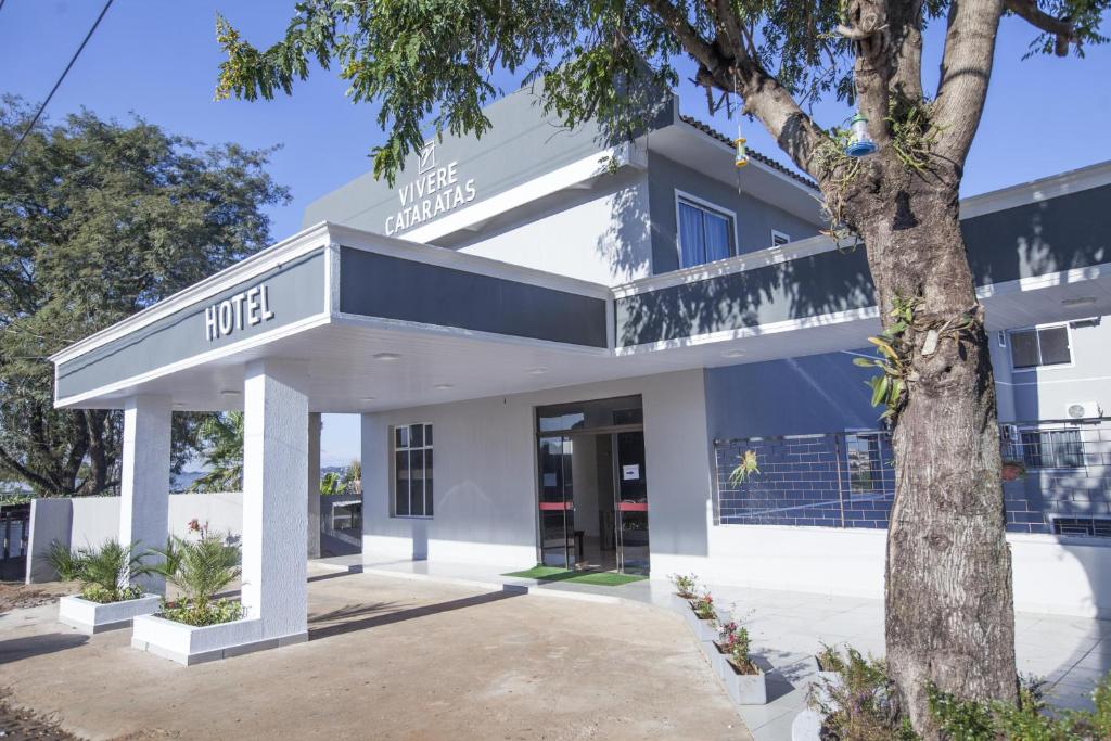 a building with a tree in front of it at Hotel Vivere Cataratas in Foz do Iguaçu