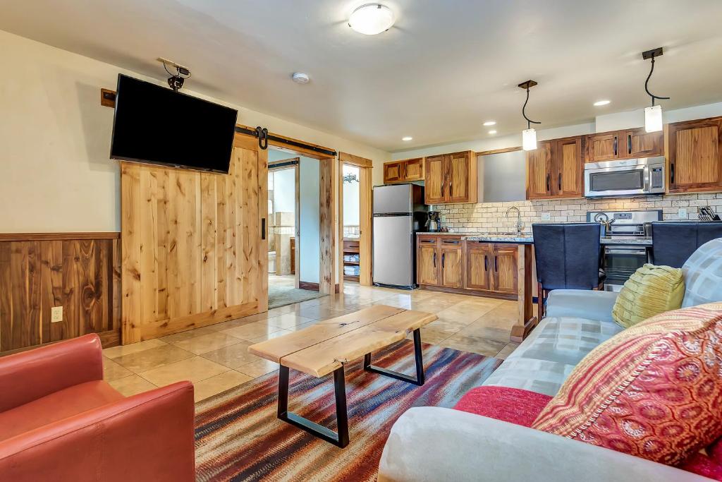 a living room filled with furniture and appliances at Wall Street Suites in Bend