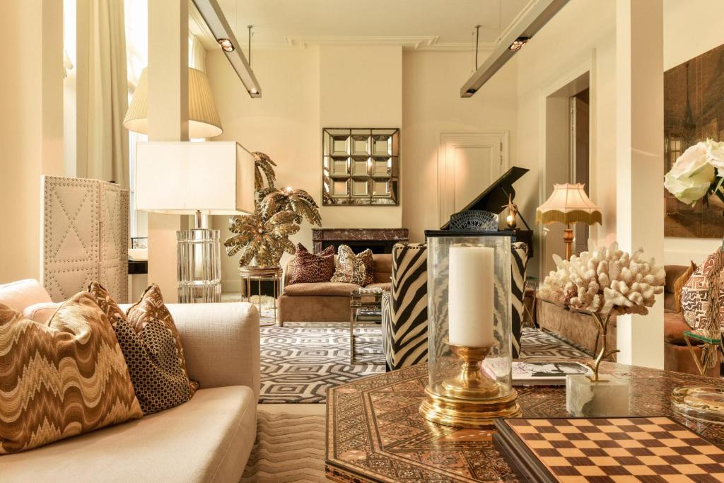 a living room with a couch and a table at Hotel Van Cleef in Bruges