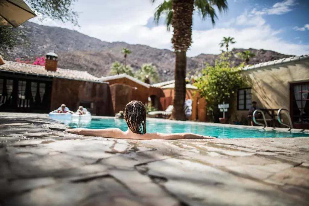 30 Best Palm Springs Hotels 4 Lady in Pool at Korakia Pensione