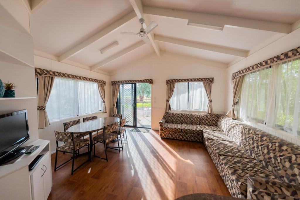 a living room filled with furniture and a window at Breeze Holiday Parks - Eildon in Eildon