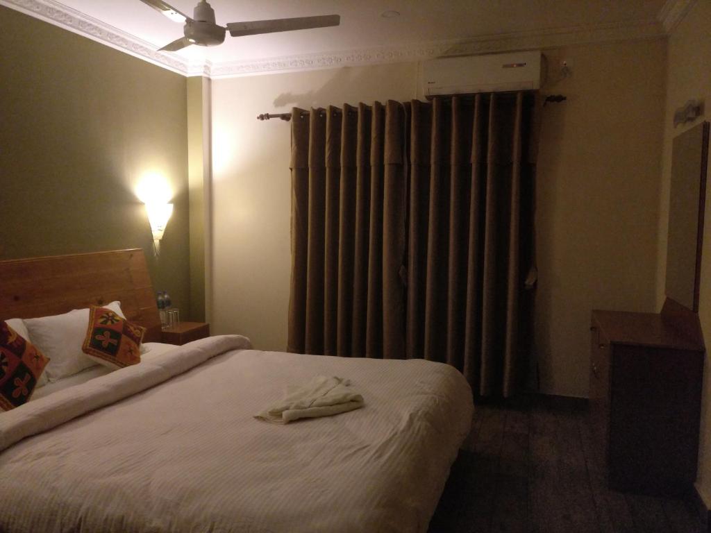 Postel nebo postele na pokoji v ubytování Hotel hornbill