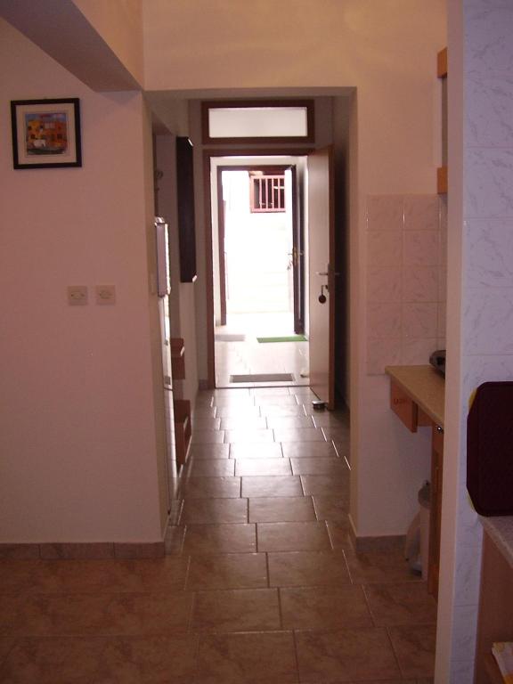 a hallway with a door and a tile floor at Apartments Meni in Drage