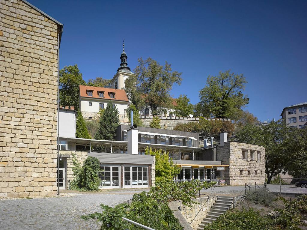 a brick building with a tower on top of it at Hotel La Romantica in Mladá Boleslav