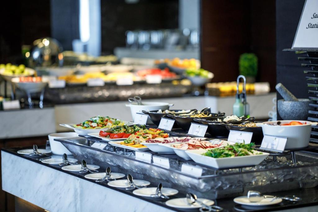 a buffet line with many different types of food at Royal M Hotel Fujairah by Gewan in Fujairah