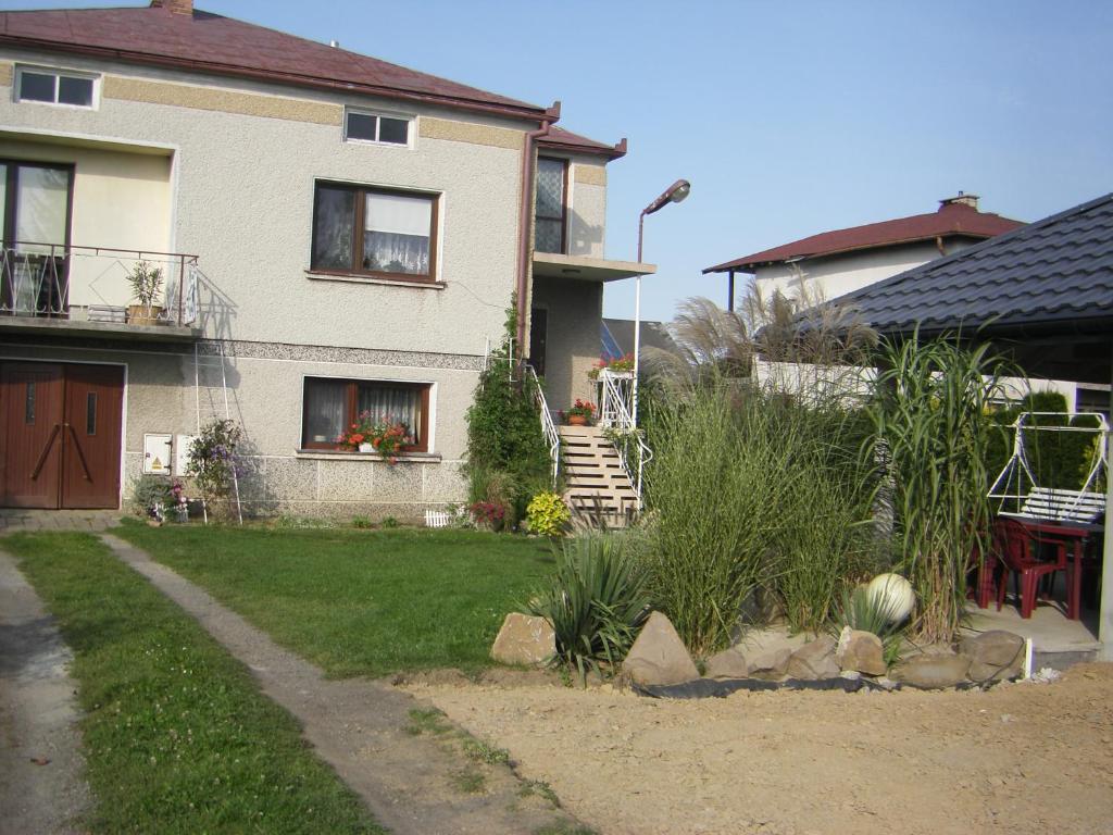 a house with a staircase leading to a yard at Lawendowy Dom in Besko