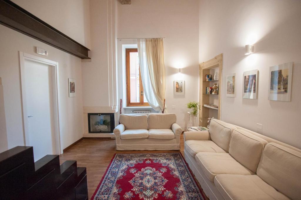 a living room with a couch and a tv at Italianflat - Verona Suite in Verona