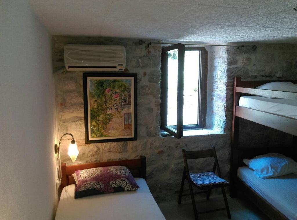 a bedroom with two bunk beds and a window at Apartments Bella in Kotor