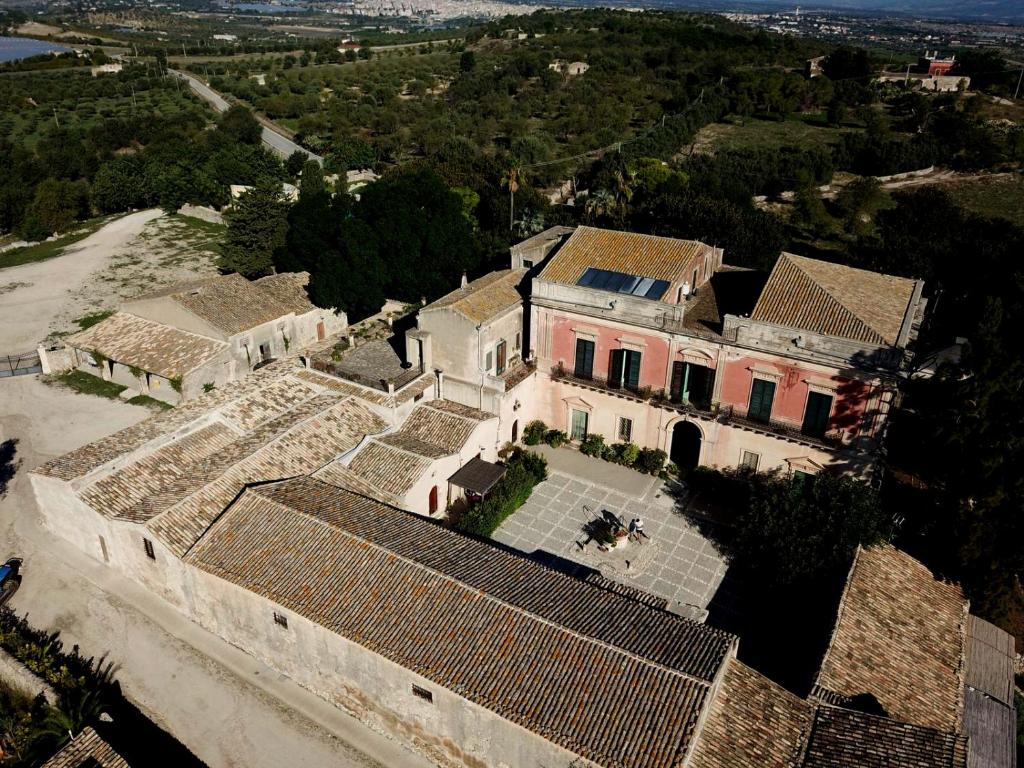 an aerial view of a large house with tile roofs at Casale Modica in Noto