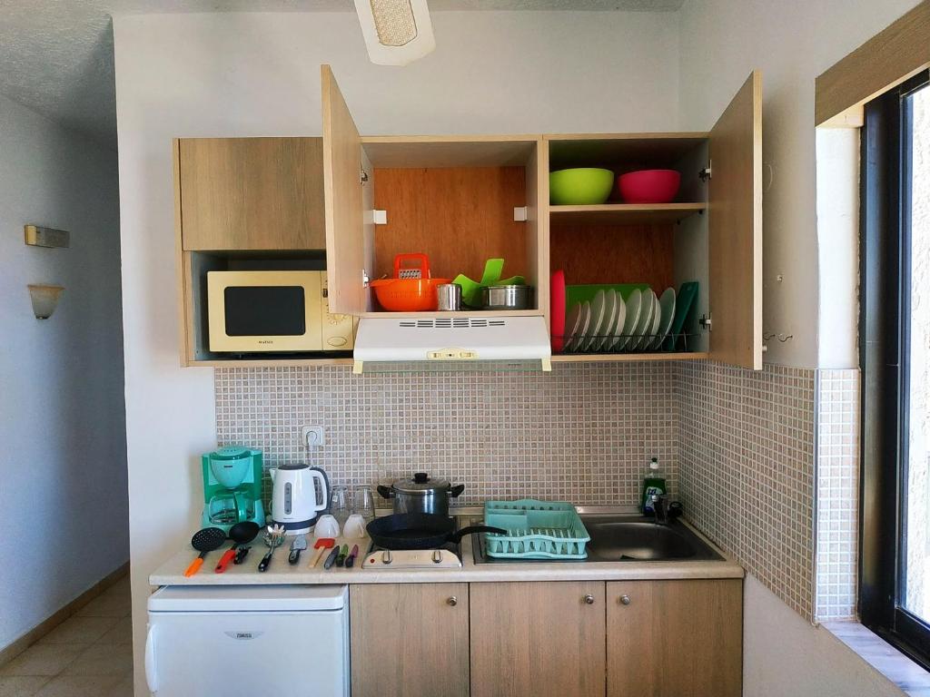 A kitchen or kitchenette at Kyriakos Studios
