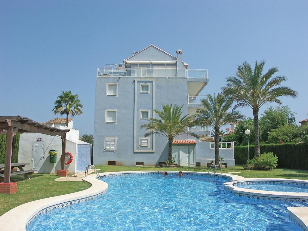 a large building with a swimming pool in front of a building at Apartment Turquesa by Interhome in Denia