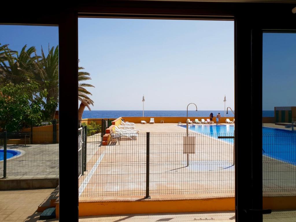 a view from the balcony of a resort with a tennis court at Beach Apartment Poris in Poris de Abona