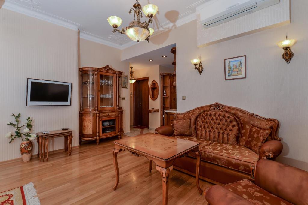 a living room with a couch and a table at Aristocratic Sofia Studio Apartment Next to Cathedral in Sofia