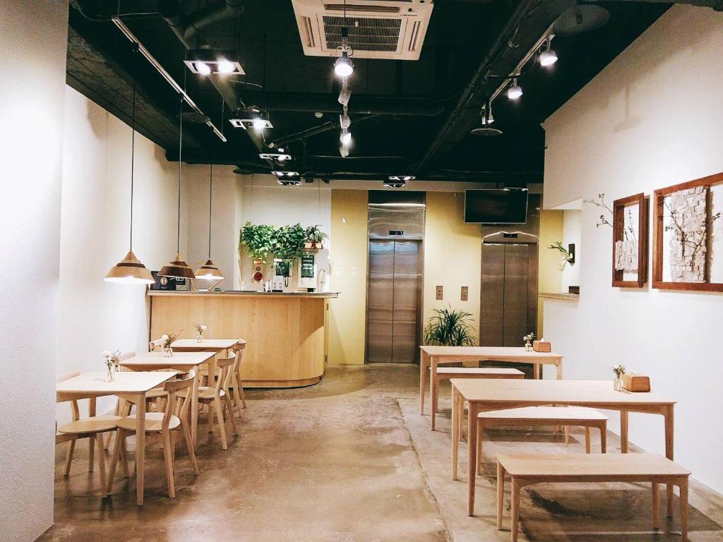 a restaurant with tables and chairs in a room at Homey House in Taipei