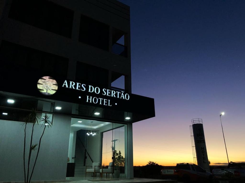 a building with a sign for ares do sergio hotel at Hotel Ares do Sertão in Chapada Gaucha