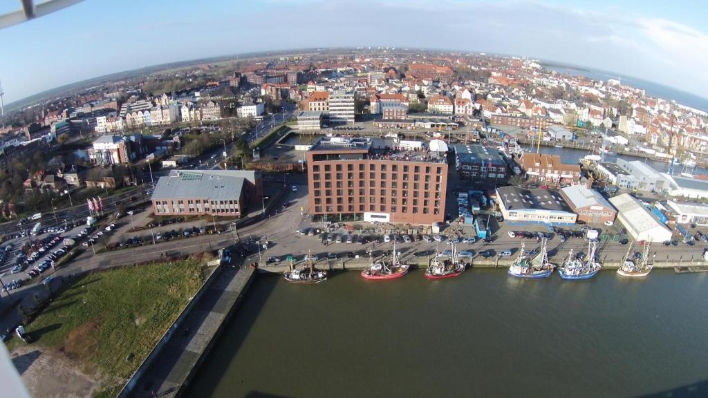 an aerial view of a city with boats in the water at havenhostel Cuxhaven in Cuxhaven