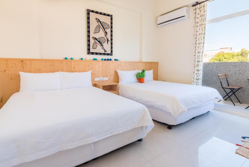 Postel nebo postele na pokoji v ubytování Cozy Green Guesthouse