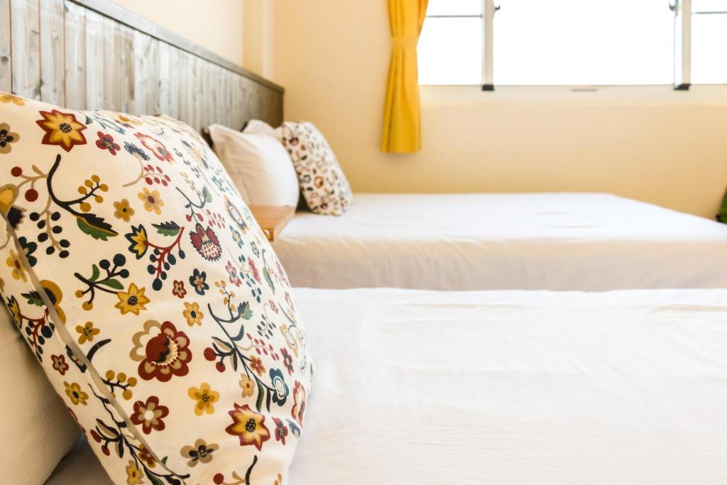 Postel nebo postele na pokoji v ubytování Cozy Green Guesthouse