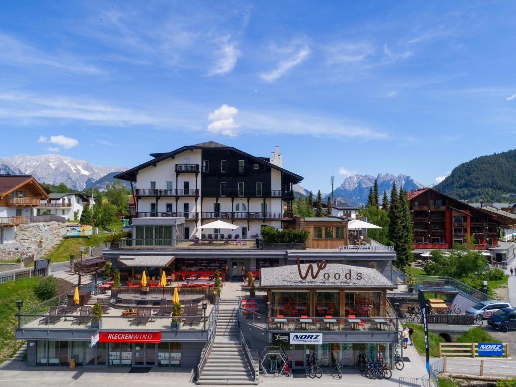 a large building in a town with mountains in the background at Hotel Wetterstein Seefeld in Seefeld in Tirol