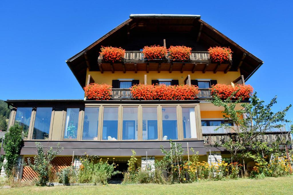 a building with flower boxes on the balconies at Privatzimmer Lasshofer in Mauterndorf