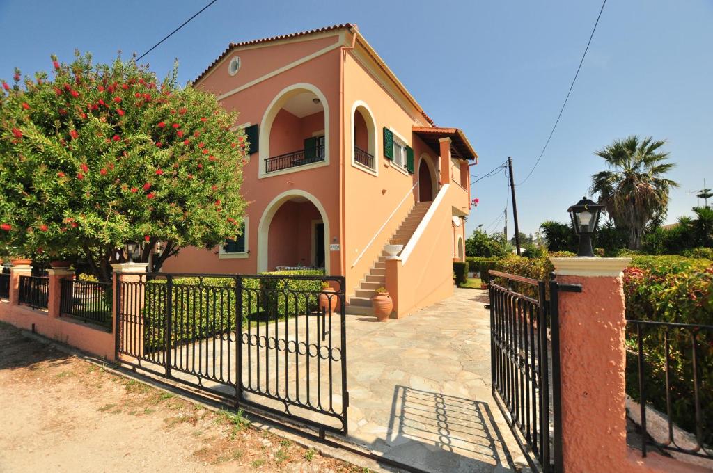 a house with a gate in front of it at Elena Apartments Corfu in Acharavi