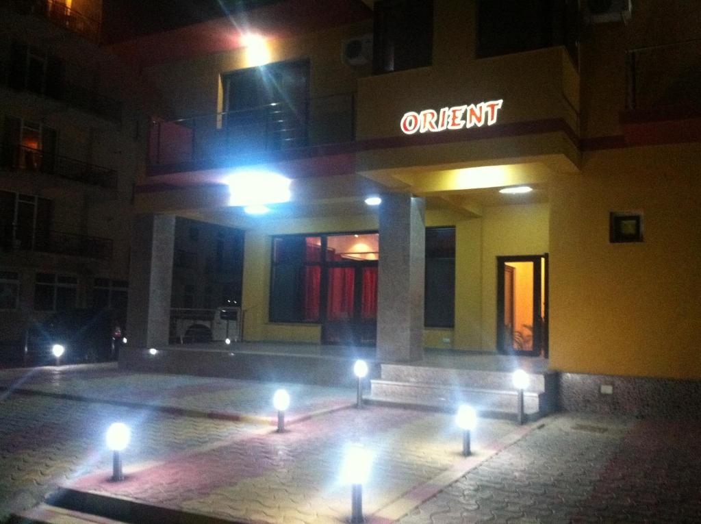 a building with lights in front of it at night at Orient Mamaia Nord in Mamaia Nord