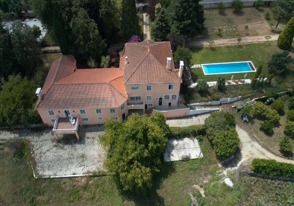 an aerial view of a house with a swimming pool at Quinta da Fogueira in Anadia