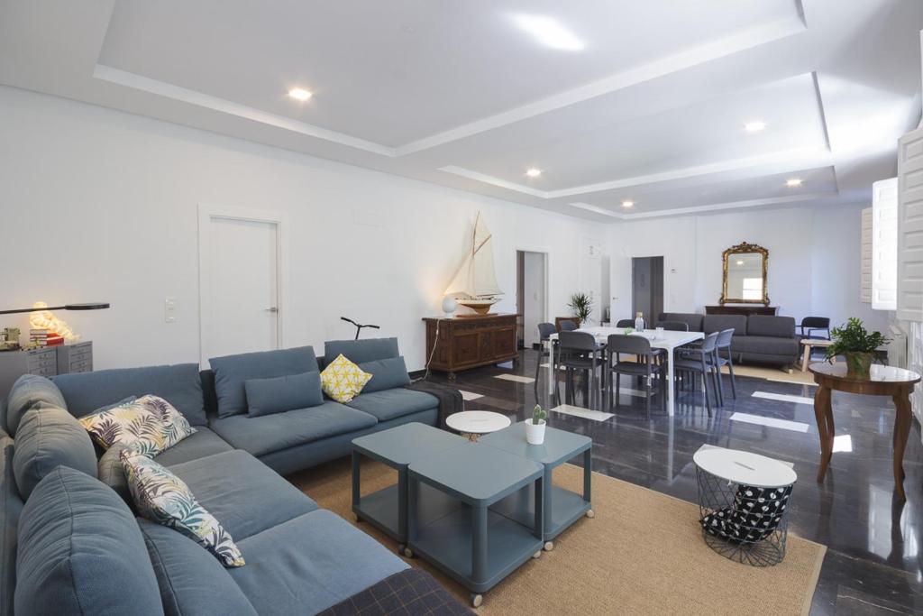 a living room with a blue couch and a table at My Way Away Suites in Zaragoza