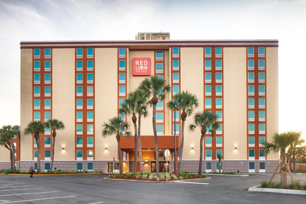 a rendering of a hotel with palm trees in front at Red Lion Hotel Orlando Lake Buena Vista South- Near Disney in Kissimmee
