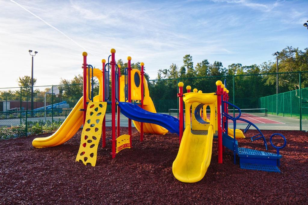 a playground with a yellow slide in a park at Red Lion Hotel Orlando Lake Buena Vista South- Near Disney in Kissimmee
