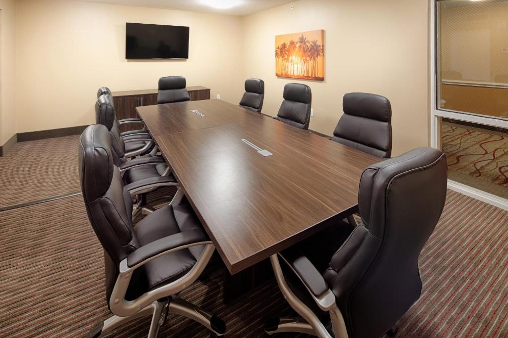 a conference room with a large wooden table and chairs at Red Lion Hotel Orlando Lake Buena Vista South- Near Disney in Kissimmee
