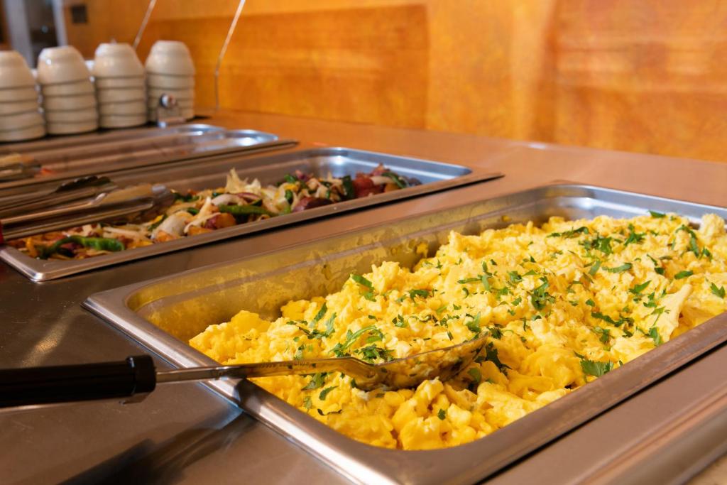 a buffet with a tray of food on a table at Red Lion Hotel Orlando Lake Buena Vista South- Near Disney in Kissimmee