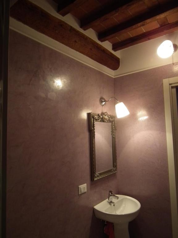 a bathroom with a sink and a mirror at Casa Toscana in Lucca
