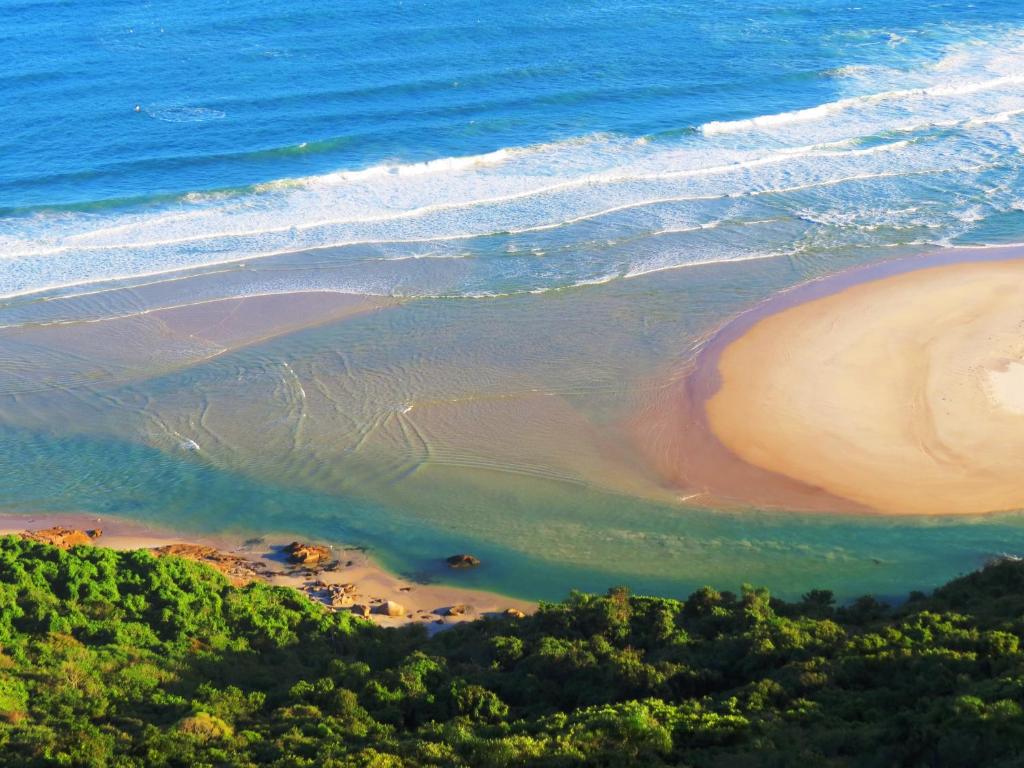 uma vista aérea de uma praia e do oceano em Moradas Girassol em Guarda do Embaú