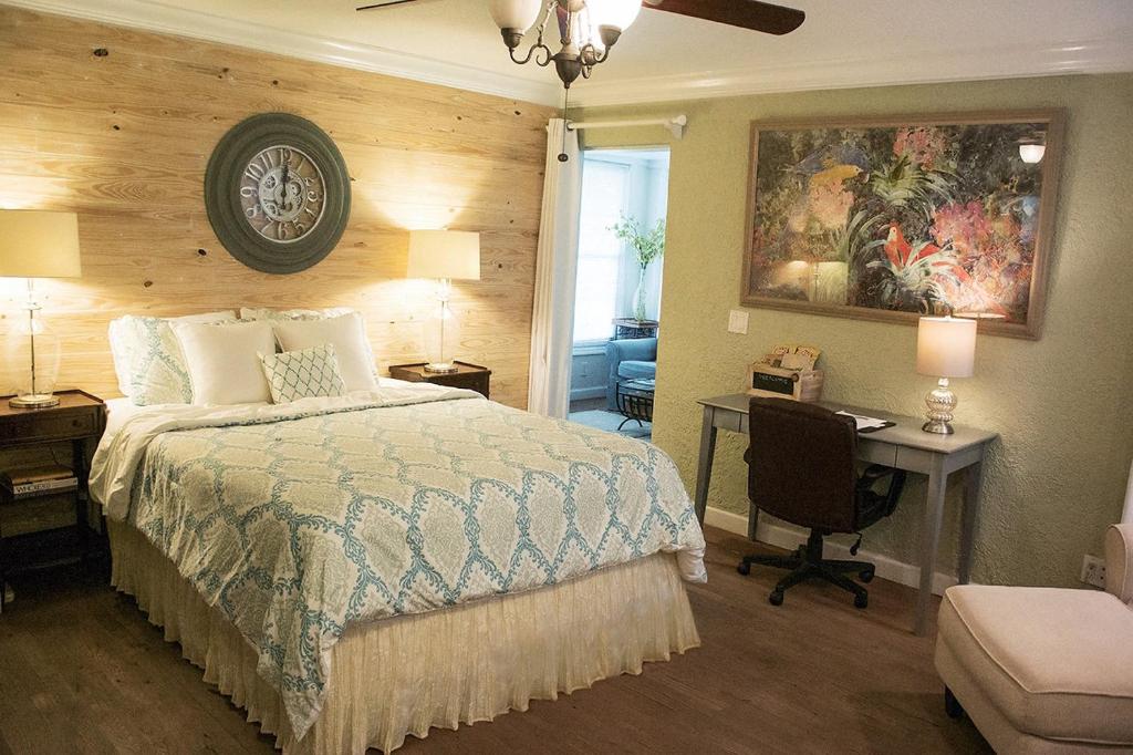 a bedroom with a bed and a desk and a chair at Winter Park charm in Orlando