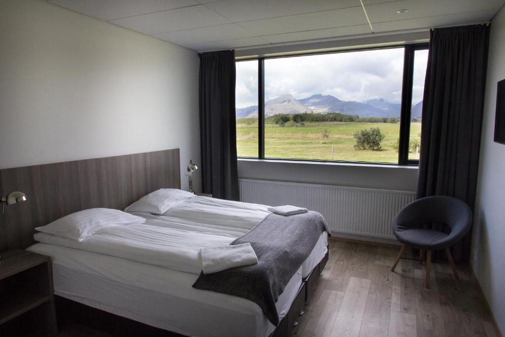 a hotel room with a bed and a window at Milk Factory in Höfn