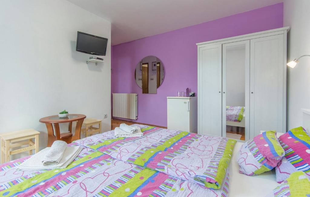 a bedroom with purple walls and a large bed at Apartment Complex Sauko in Poreč
