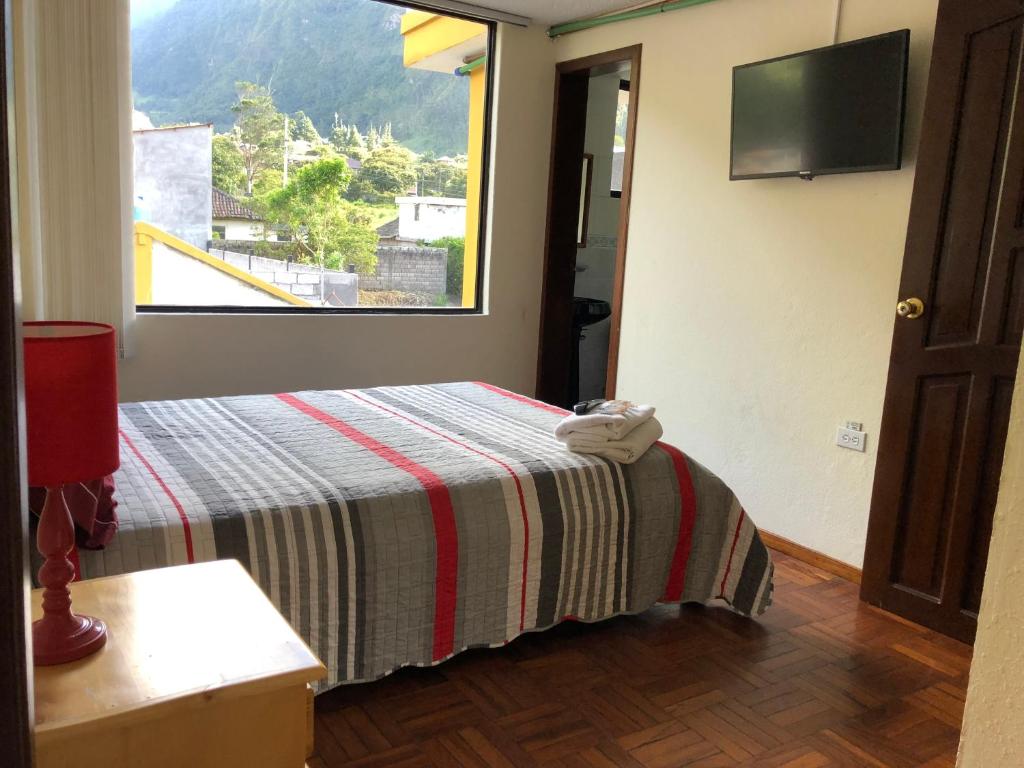 Postel nebo postele na pokoji v ubytování Hostal Monte Carmelo