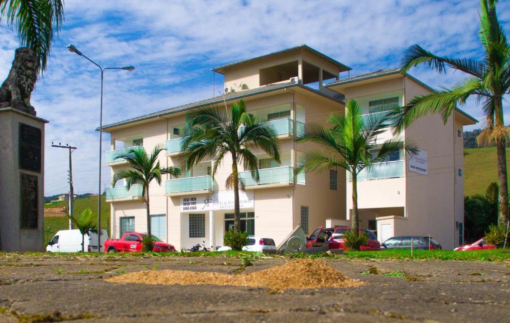 a building with palm trees in front of it at Hotel Rio Fortuna in Rio Fortuna