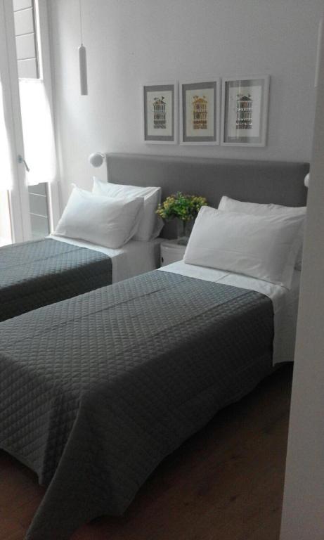 A bed or beds in a room at San Marco Design Suites