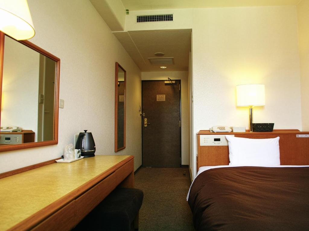 Postel nebo postele na pokoji v ubytování Tourist Hotel Hitachi