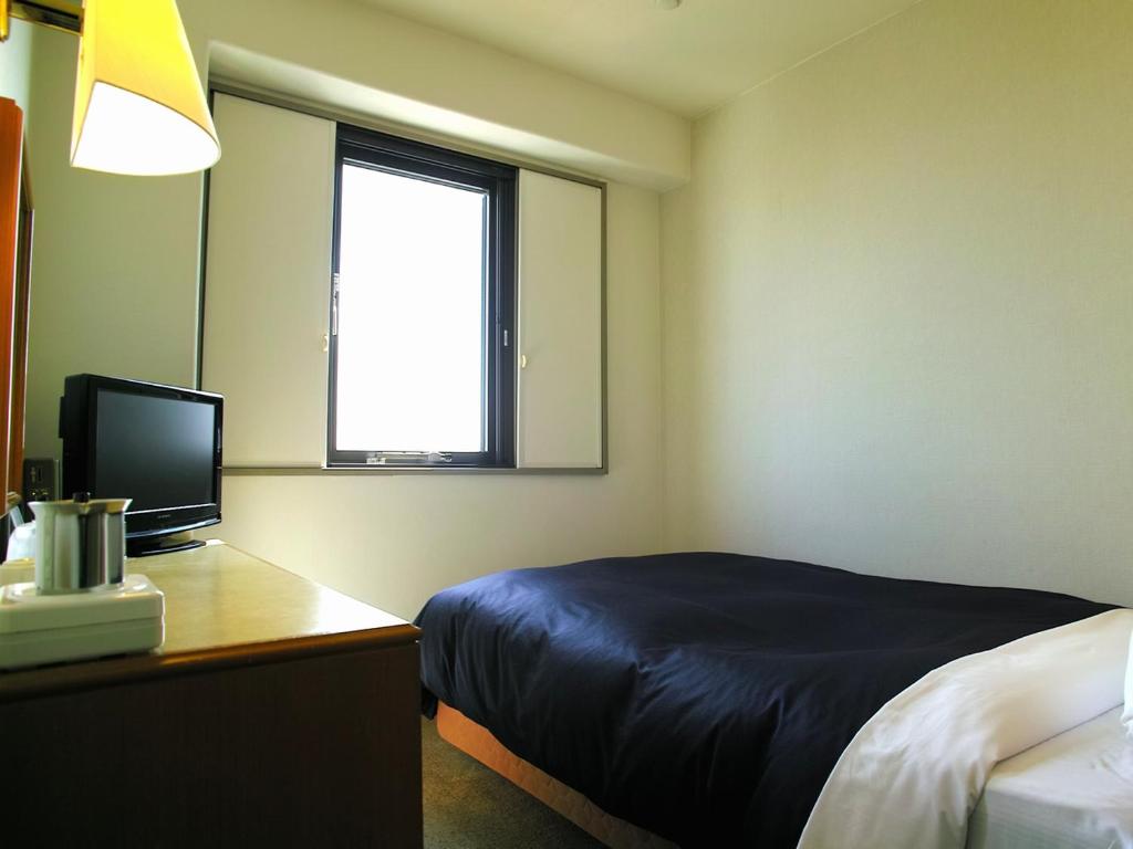 Postel nebo postele na pokoji v ubytování Tourist Hotel Hitachi