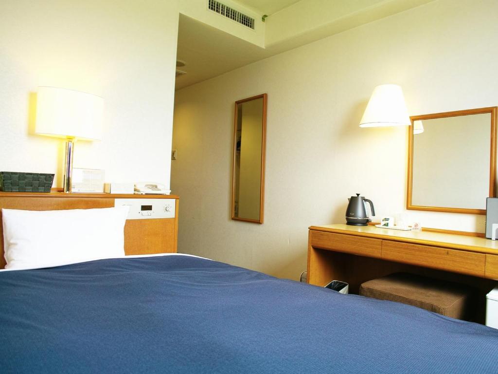 Postel nebo postele na pokoji v ubytování Tourist Hotel Hitachi