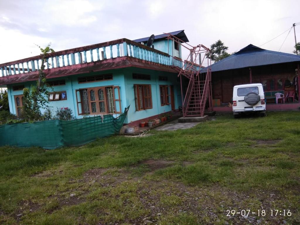 a house with a van parked in front of it at VAMOOSETRAIL PASIGHAT(1) in Pāsighāt