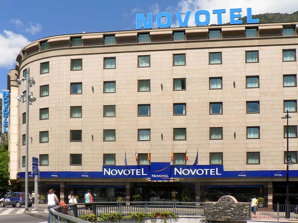 a large building with a sign on the side of it at Novotel Andorra in Andorra la Vella