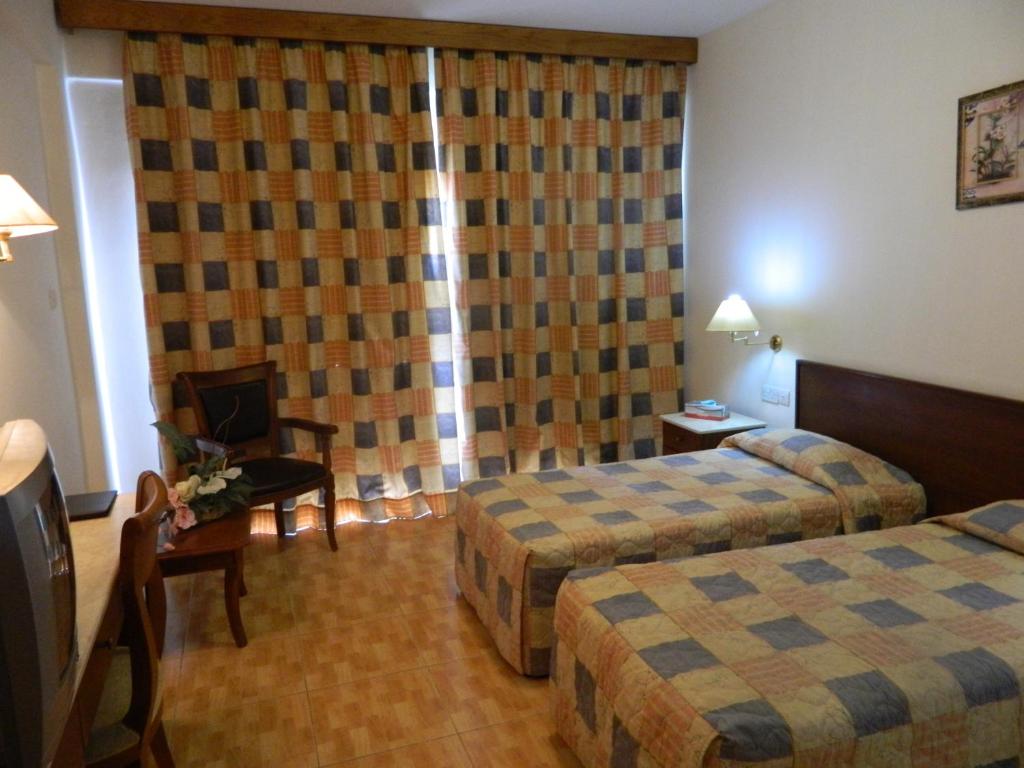 Postel nebo postele na pokoji v ubytování M. Moniatis Hotel
