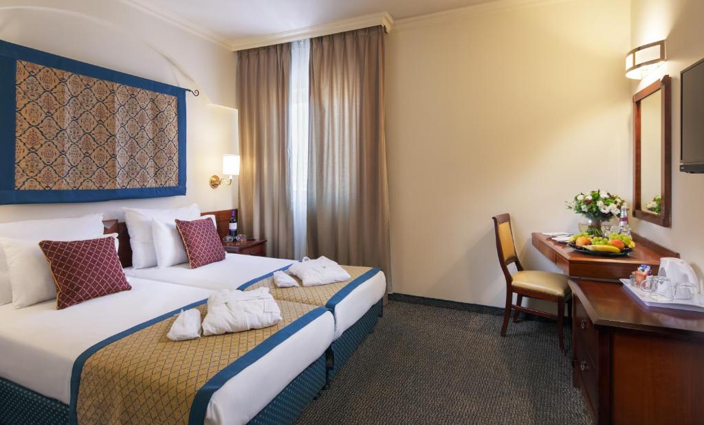 Postel nebo postele na pokoji v ubytování Prima Palace Hotel